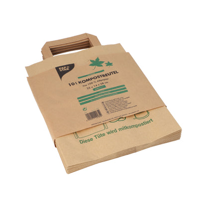 Een stapel PAPSTAR compostzakken van papier met handvat, 28x22x14 cm, bruin (15 stuks), voorzien van de tekst "10 l compostzakken", voor het verzamelen van keukenafval, ligt plat op een witte achtergrond. Merk: PAPSTAR GmbH.