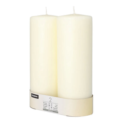 Twee onbelichte Starpak 2 stompkaarsen Ø 80 mm met platte kop staan naast elkaar, omwikkeld met een gelabelde band aan de onderkant en stralen tijdloze elegantie uit.