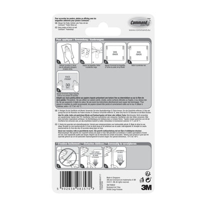 Achterkant van een verpakking Command™ Poster-Strips 17024 van 3M Deutschland GmbH met geïllustreerde stap-voor-stap instructies voor residuvrije bevestiging en het ophangen van posters in meerdere talen, met diagrammen, barcode en 3M branding rechtsonder.