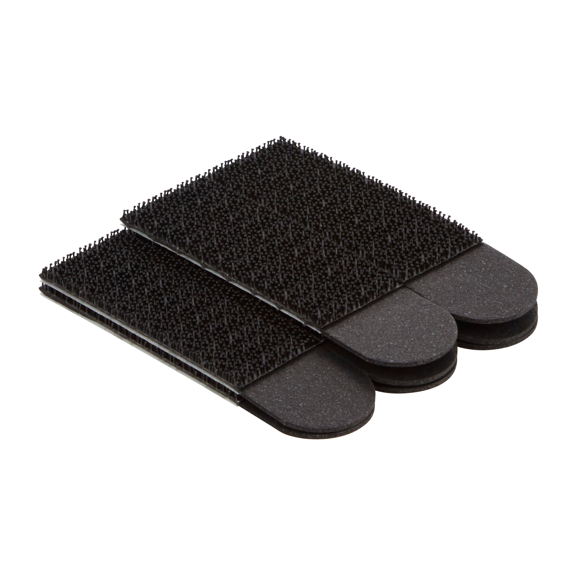 Drei schwarze rechteckige Bürsten-Reinigungspads mit strukturierten Borsten, gestapelt auf weißem Hintergrund - perfekt für die Verwendung mit 3M Deutschland GmbH Command™ Bilder-Montage Strips 17201BLK, Mittelgroße, Schwarz (4 Sets) zum Aufhängen von Bildern ohne Nägel und einfaches Entfernen.