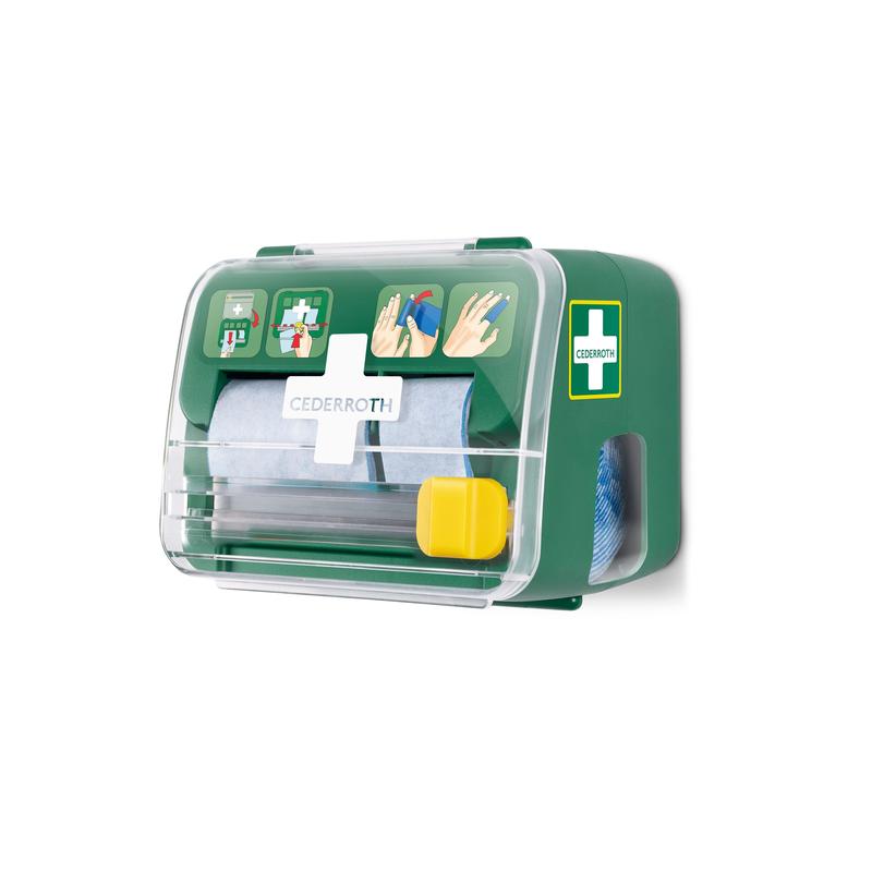 Een groene, transparante Cederroth schuimverband 2-in-1 dispenser van Orkla Wound Care AB is aan een witte muur gemonteerd, houdt verpakt materiaal vast en toont aan de voorkant een geïllustreerde EHBO-handleiding.