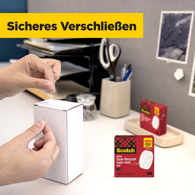 Een persoon sluit een wit pakket op tafel met Scotch® Super-Hold Secure Tape, 1 rol, 19 mm x 25,4 m van 3M Deutschland GmbH. Op de achtergrond zijn kantoorbenodigdheden en de verpakking van de transparante plakband te zien.