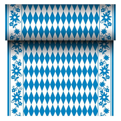 De PAPSTAR tafelloper Airlaid "Bayrisch Blau" (24 m x 40 cm) van PAPSTAR GmbH is een stofachtige tafelloper met een blauw-wit ruitpatroon in het midden en een blauwe bloemenrand. De rol toont bij het afrollen zijn zich herhalende Beierse patroon.