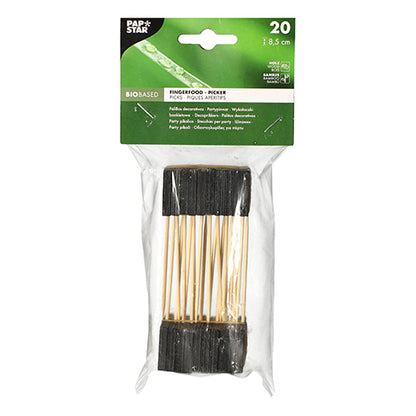 Een doorzichtige plastic verpakking bevat 20 PAPSTAR fingerfood-prikkers, 8,5 cm, zwart - ideaal voor buffetten en feestjes. Het bovenste etiket toont productdetails op een groene achtergrond met witte tekst. Merk: PAPSTAR GmbH.