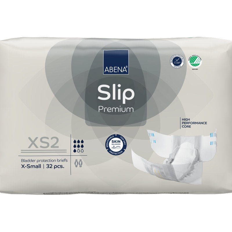 Een 32-pack ABENA Slip Premium van Abena Re-Seller GmbH in de maat XS2 X-Small in beige verpakking met de certificeringen "High Performance Core" en "Skin Friendly" voor betrouwbare incontinentiezorg.
