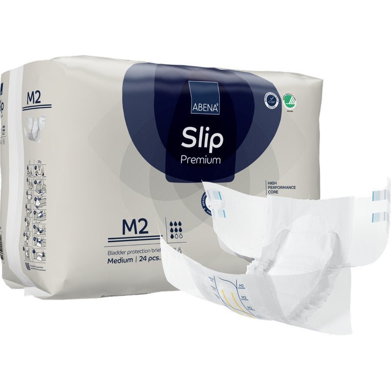 Achter een opengevouwen luier is een verpakking ABENA Slip Premium van Abena Re-Seller GmbH, maat M2, afgebeeld. Op de verpakking staat dat deze 24 middelgrote slips voor betrouwbare incontinentiezorg bevat.