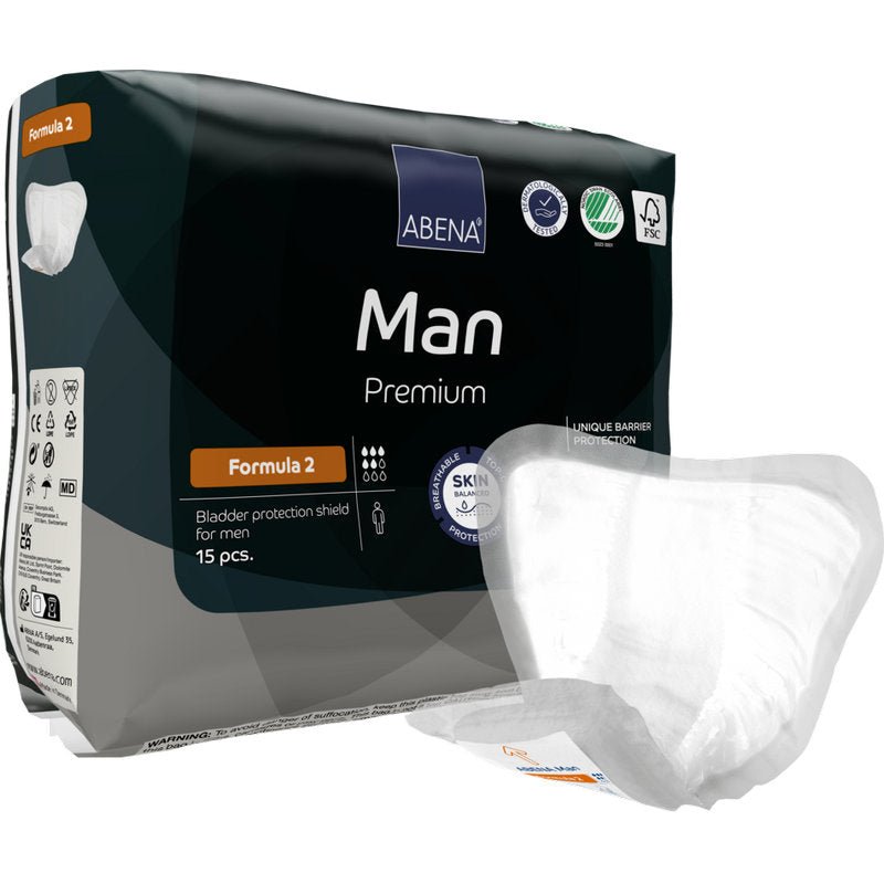 Afgebeeld is een verpakking ABENA Man Formula Premium van Abena Re-Seller GmbH met een bord op de voorgrond. De verpakking bevat 15 stuks en benadrukt de huidvriendelijke en barrièrebeschermende eigenschappen.