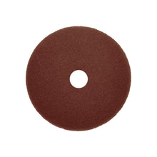 Ein rundes, dunkelbrauner Arcora Sunshine Strong Plus No1+ Pad von Arcora International GmbH mit strukturierter Oberfläche und Loch, auf weißem Hintergrund fotografiert. Erhältlich im Karton (10 Stück).