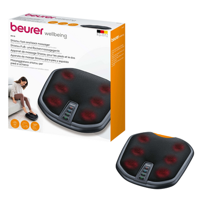 De afbeelding toont het Beurer FM 70 Shiatsu voet- en rugmassageapparaat en benadrukt de inschakelbare verwarmingsfunctie. Het zwarte apparaat heeft zichtbare rode massageknopen en meerdere bedieningsknoppen. De verpakking bevat een foto van een persoon die geniet van de voet- en rugmassage, evenals productdetails in meerdere talen.
