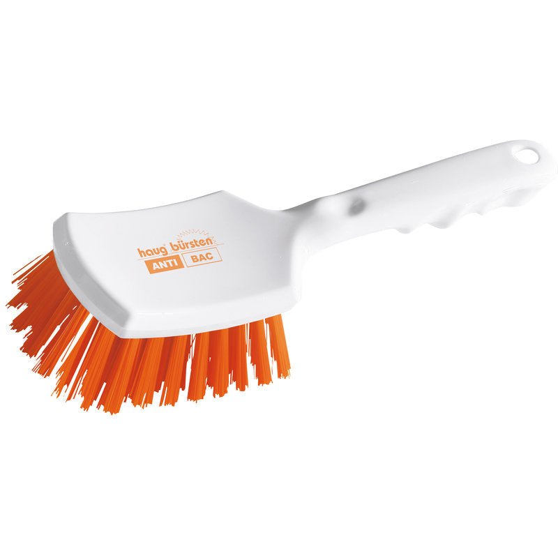 Haug Bürsten KG ANTI BAC steelborstel van wit kunststof met licht gebogen handgreep en stijve oranje PBT-borstelharen (ø 0,50 mm), die onder een hoek staan voor schrobben. Op de borstelkop zijn "ANTI BAC" en "Haug Bürsten" gedrukt. Afmetingen: 260x72x35mm.