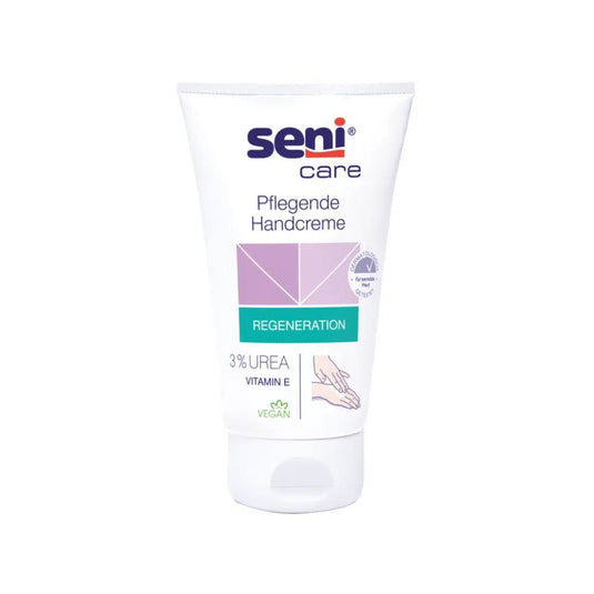 Op de afbeelding is een tube van de verzorgende handcrème te zien Seni Care van TZMO Deutschland GmbH tegen een witte achtergrond. Op het etiket wordt gewezen op de eigenschappen „regeneratie“ en „veganistisch“ en wordt de nadruk gelegd op de formule met 3% ureum en vitamine E voor een hydraterende werking.