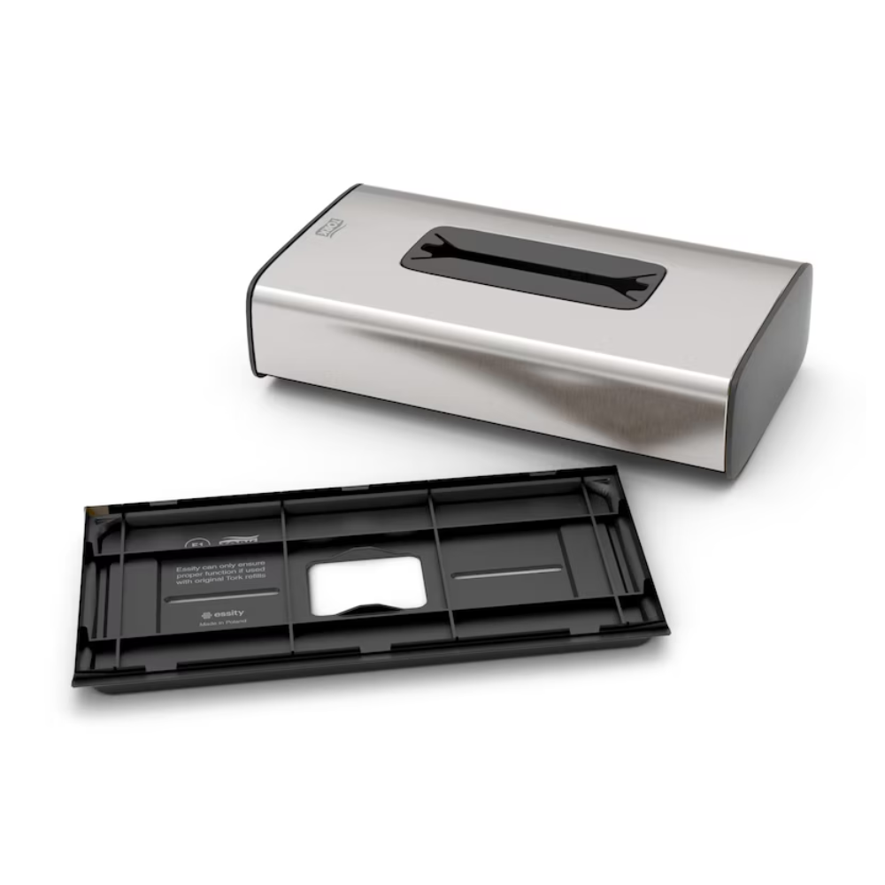 De Tork 460013 dispenser voor cosmetische tissues Image Line F1, een wandgemonteerde tissue-dispenser van roestvrij staal van TORK - Essity Professional Hygiene Germany GmbH, wordt getoond met verwijderde en vooruitgeschoven afneembare achterwand. Deze dispenser met elegant roestvrijstalen design en een kijkvenster aan de bovenkant maakt eenvoudig navullen en het uitnemen van enkele vellen mogelijk in openbare toiletten.